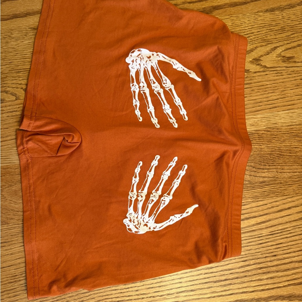 Orange Shorts with Skeleton Hand Design